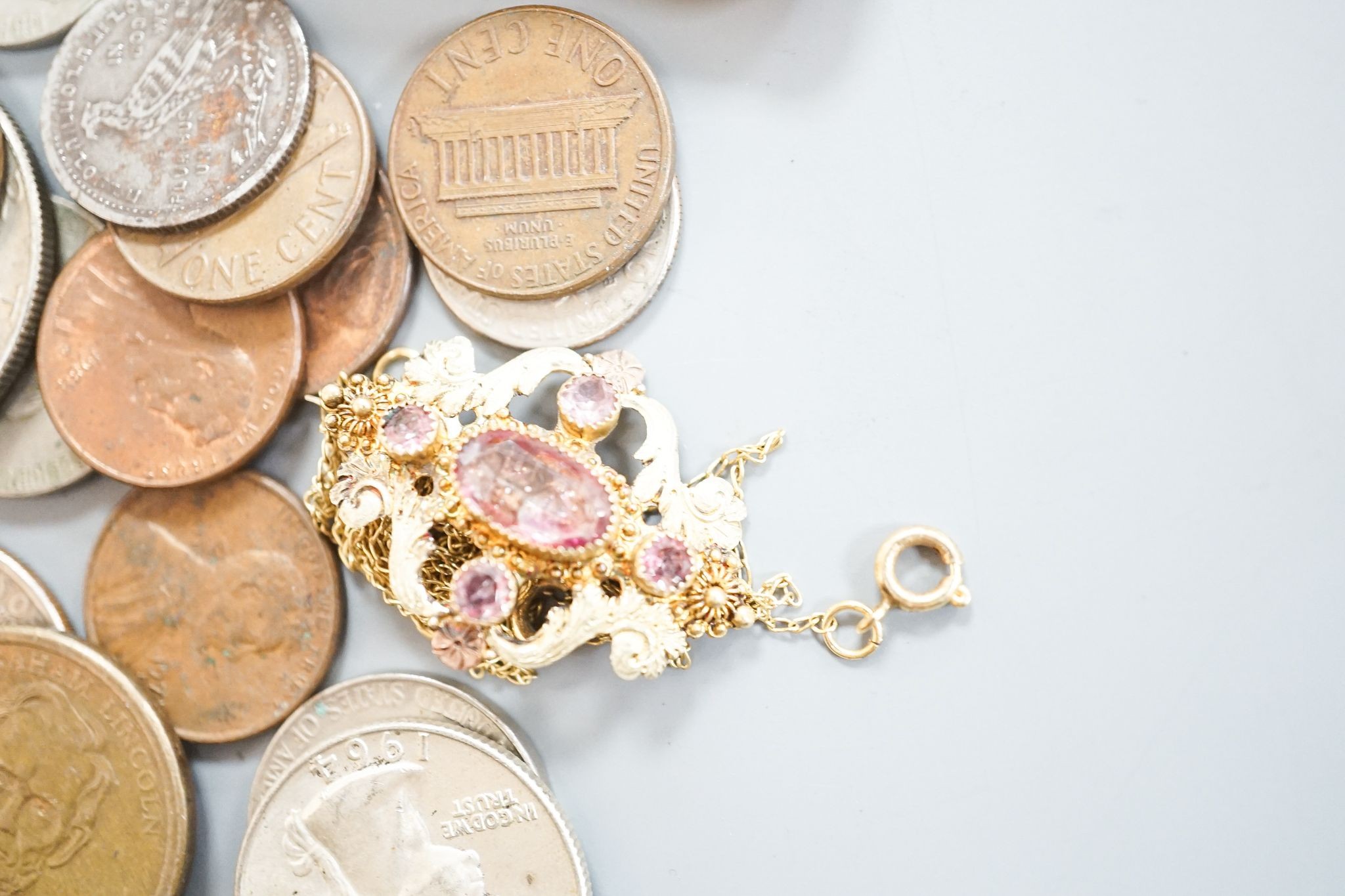A 19th century two colour yellow metal and pink topaz set brooch, 30mm, an amber cigarette holder, gilt metal chain and a group of assorted coinage and bank notes.